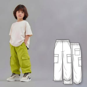 May include: A child wearing a cream-colored t-shirt and bright green cargo pants. The pants have large pockets and a relaxed fit. The child is wearing white and beige sneakers. A technical drawing of the pants is also shown.