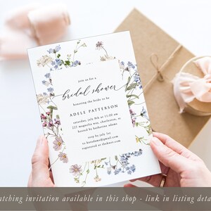 May include: A white bridal shower invitation with a floral border. The text reads "Join us for a bridal shower honoring the bride to be Adele Patterson, Saturday, July 8th at 11:00 am, 217 Magnolia Ave, Charleston, SC, hosted by Katherine Adams, RSVP by July 1st to hatadam@gmail.com, registered at theknot.com".