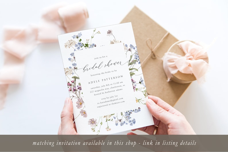May include: A white bridal shower invitation with a floral border. The text reads "Join us for a bridal shower honoring the bride to be Adele Patterson, Saturday, July 8th at 11:00 am, 217 Magnolia Ave, Charleston, SC, hosted by Katherine Adams, RSVP by July 1st to hatadam@gmail.com, registered at theknot.com".