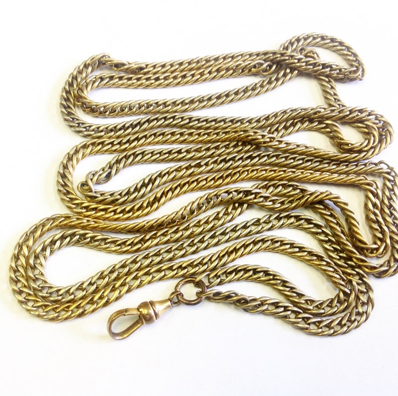 58 inches long. Antique around 150 cm very long guard chain muff chain
