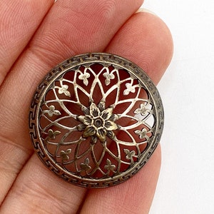 Antique Victorian pierced metal button in floral design with Greek key border.