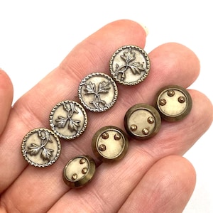 Collection of Austrian Tiny buttons, eight buttons in two sets.
