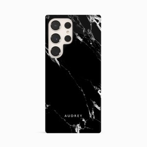 a black and white marble phone case with the name audry on it