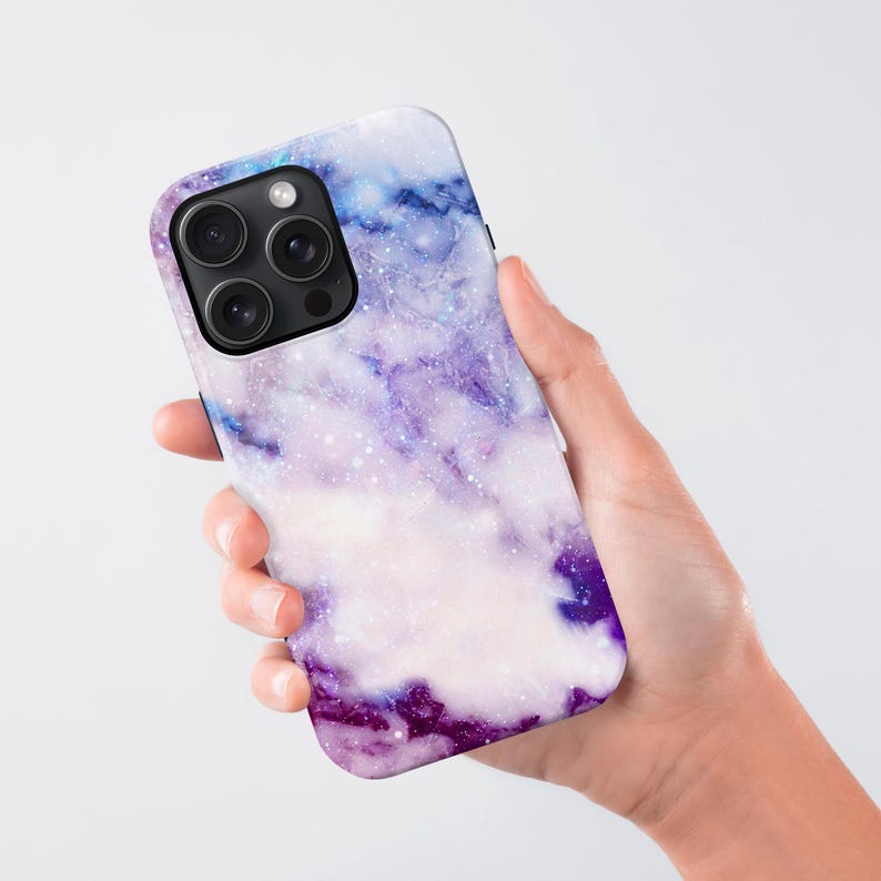 a hand holding a purple and blue phone case