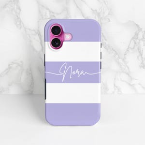 purple and white stripes phone case with a personalised cursive name, shown on an iPhone as an example and stood up against a marble background