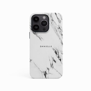 a white marble phone case with the name danielle on it