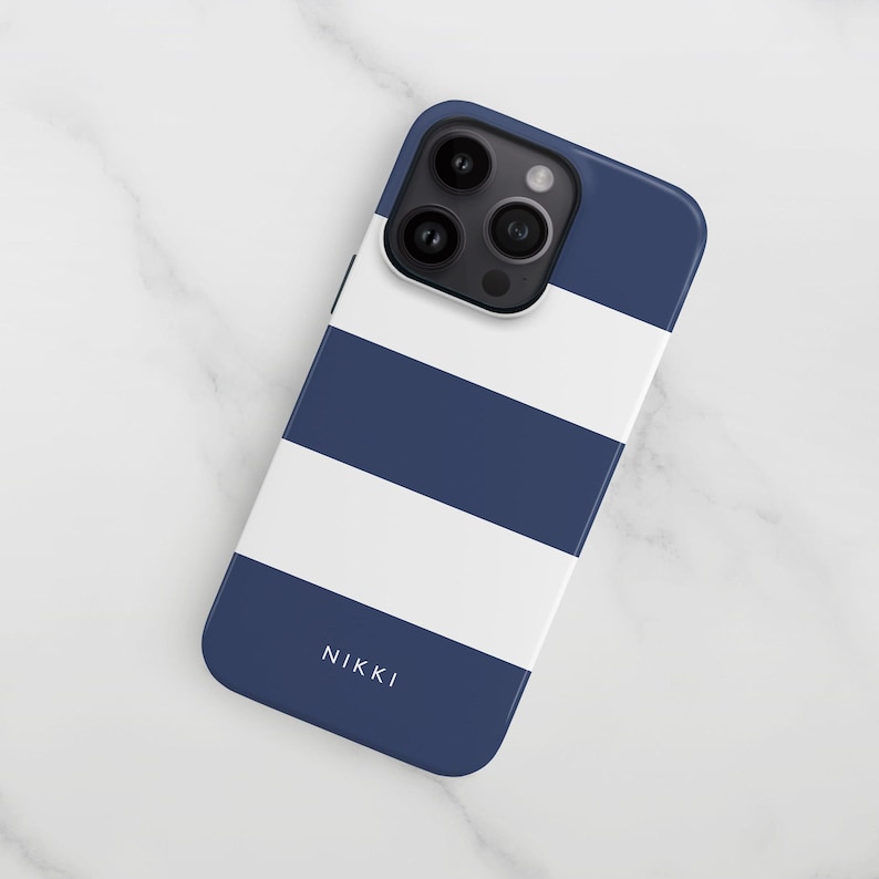 a blue and white iphone case sitting on a marble surface