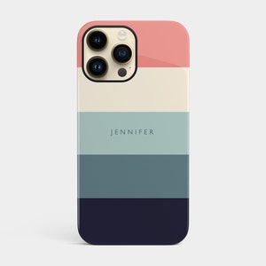 May include: A phone case with a striped design in shades of pink, cream, blue, and navy. The case has the name "JENNIFER" printed on it.