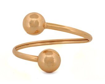 Pulsera de puño de oro con doble orbe