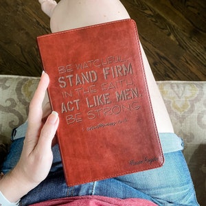 May include: A brown leather-bound journal with the words "Be Watchful, Stand Firm in the Faith, Act Like Men, Be Strong" embossed on the front cover. The text "I Corinthians 16:13" is also embossed on the cover. The journal is signed "Mason Rogers".