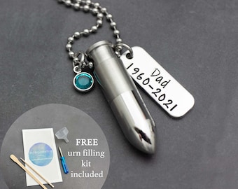 May include: Silver necklace with a bullet-shaped urn pendant, a small teal gemstone, and a silver tag engraved with "Dad 1960-2021". The necklace comes with a free urn filling kit.