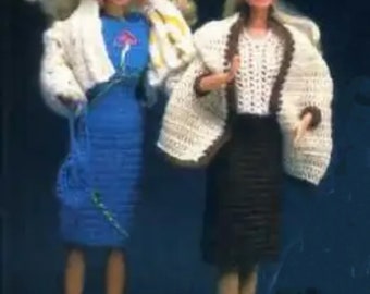 May include: Two Barbie dolls wearing crocheted outfits. The doll on the left is wearing a blue dress with a white crocheted jacket and a blue hat. The doll on the right is wearing a white crocheted top with a brown crocheted jacket and a brown skirt.