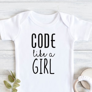 May include: White baby onesie with black text that reads "CODE like a GIRL".