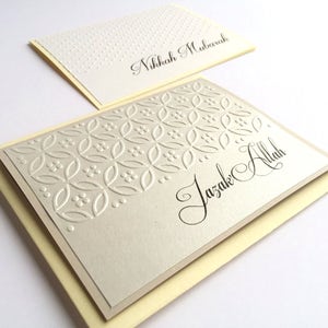May include: Two cards with a decorative pattern and the text "Nikkah Mubarak" and "Jazak Allah" in calligraphy.