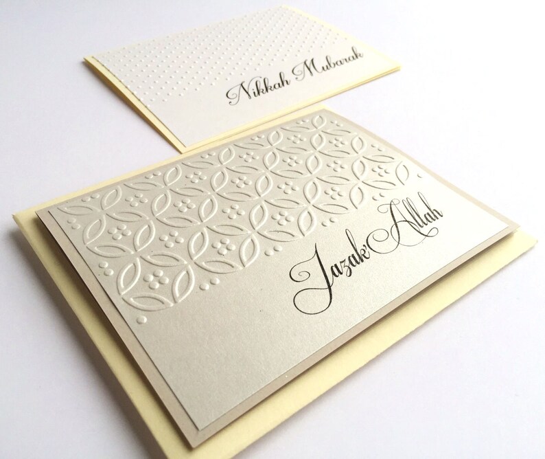 May include: Two cards with a decorative pattern and the text "Nikkah Mubarak" and "Jazak Allah" in calligraphy.