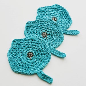 May include: Three teal blue crocheted coasters with a gray center. The coasters are shaped like leaves with a pointed tip.