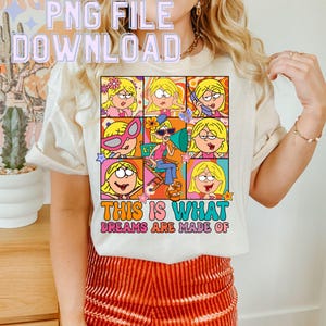 Op de afbeelding: Een wit T-shirt met een kleurrijke afbeelding van een cartoonmeisje in verschillende poses. De tekst "This is what dreams are made of" staat onder de afbeelding.