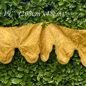 May include: Gold fabric valance with a scalloped edge. The valance measures 82 inches by 19 inches (208 cm x 48 cm).