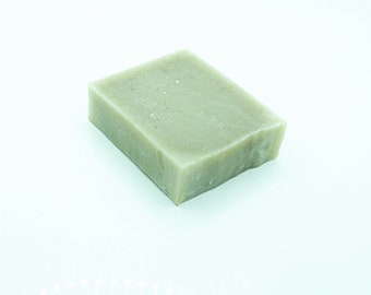 May include: A rectangular bar of green soap. The soap has a rough, textured surface.