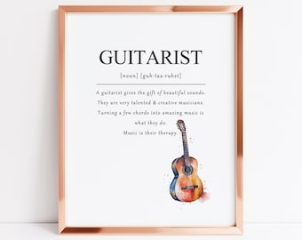 May include: A watercolor illustration of an acoustic guitar with the definition of the word "guitarist" in black text. The definition reads: "[noun] [guh-taa-ruhst] A guitarist gives the gift of beautiful sounds. They are very talented & creative musicians. Turning a few chords into amazing music is what they do. Music is their therapy."