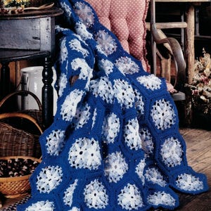 May include: A crochet blanket featuring a repeating pattern of hexagonal motifs. Each hexagon consists of a solid royal blue border surrounding a central white and light blue floral-like design. The text PDF File PATTERN is in the corner.