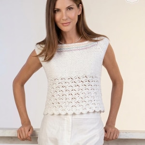 May include: A white crochet top with a scalloped hem and a decorative pattern. The top has a scoop neckline with a thin stripe of pastel colors. The image also includes the text "CROCHET PDF PATTERN".