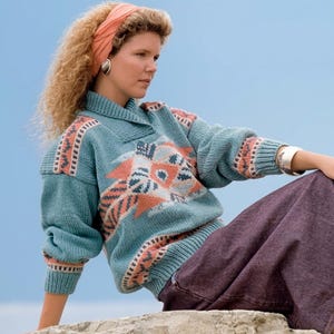 May include: A teal knit sweater featuring a shawl collar and a geometric pattern in shades of peach, white, and dark blue across the chest and sleeves. The sweater has ribbed cuffs and a ribbed hem, with the text PDF FILE PATTERN visible in the corner.