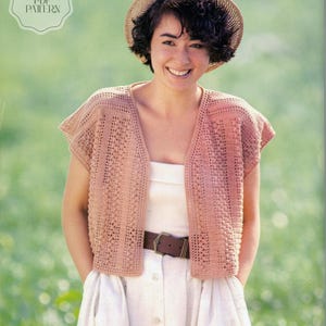 May include: A woman wearing a light brown crochet vest over a white dress, paired with a straw hat and a brown belt. The vest features a detailed openwork pattern. The image includes the text "CROCHET PDF PATTERN" in a circular design.