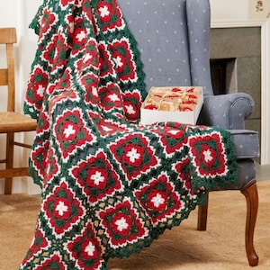 May include: A handmade crochet blanket in red, white, and green, draped over a blue armchair. The blanket features a repeating square pattern with floral motifs. The words "PDF File Pattern" are visible in the bottom right corner.