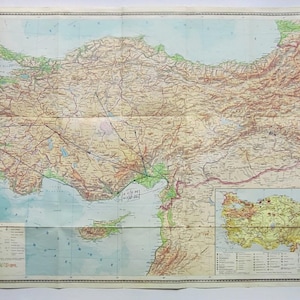 May include: A vintage map of Turkey, featuring detailed geographical information. The map displays the country's topography with various colors and labels. The map is folded and has a smaller inset map. The text "Turkey" is visible at the top.