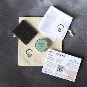 May include: A metal care kit with a small tin of wax, a polishing cloth, a wire pad, and instructions. The kit is packaged in a white bag with a logo that says "Coach House Forge".