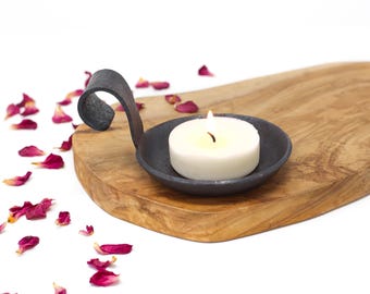 Sculpted Iron Candle Holder with curved handle.