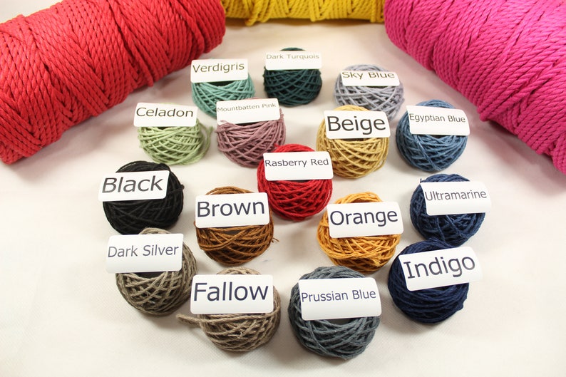 May include: A collection of 16 balls of cotton cord in various colors, including black, brown, orange, beige, red, blue, green, and gray. Each ball has a white label with the color name printed on it.
