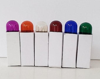 May include: Six small light bulbs in individual white boxes. The bulbs are clear glass with colored tops: purple, orange, white, red, blue, and green.