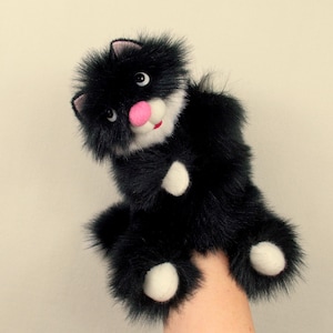 Puppet Black Fluffy Cat for children. Soft, pleasant and cheerful toy cat for children's performances, games and educational activities.