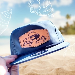 May include: A blue baseball cap with a brown leather patch that says "Stay Salty, The World Needs It, Matt. 5:13".
