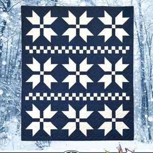 May include: A blue and white quilt pattern with a snowflake design. The quilt is titled "Sweater Weather" and is by Running Doe Quilts for Villa Rosa Designs.