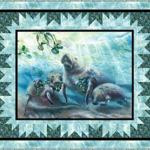 May include: A quilt featuring a serene underwater scene with three manatees. The central image is framed by a black border and a light blue patterned border. The manatees are depicted in shades of gray and blue, with aquatic plants.