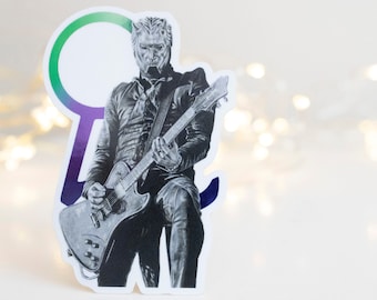 May include: A black and white sticker of a musician playing a guitar. The musician is wearing a black jacket and trousers. The sticker is on a white background.