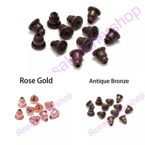 May include: Two sets of earring backs in rose gold and antique bronze. Each set contains 10 earring backs.