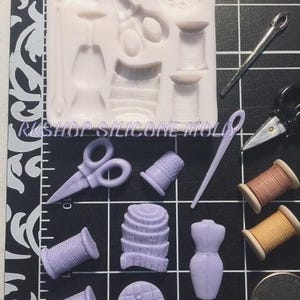 May include: A silicone mold for making various sewing-themed decorations. The mold features a thimble, spool of thread, scissors, buttons, and a sewing needle.
