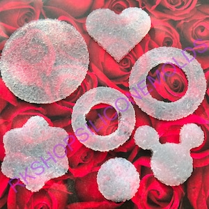 May include: A set of seven clear silicone molds with a textured surface. The molds are shaped like a circle, heart, ring, star, Mickey Mouse head, and two small circles.