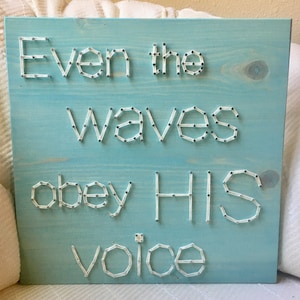 May include: A light blue wooden sign with the words "Even the waves obey HIS voice" created using string art.