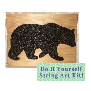 May include: A black bear string art kit on a wooden background. The kit includes all the materials needed to create the string art, including the wood, nails, and string. The finished product is a beautiful and unique piece of art that can be displayed in any home.
