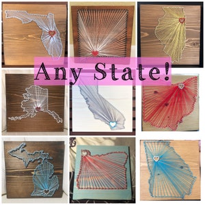 May include: A collage of string art pieces featuring different states in the United States. Each state is outlined in string and has a heart in the center. The states featured are Florida, Illinois, Alaska, California, Ohio, Michigan, Oregon, and Georgia. The text "Any State!" is written in pink across the middle of the collage.