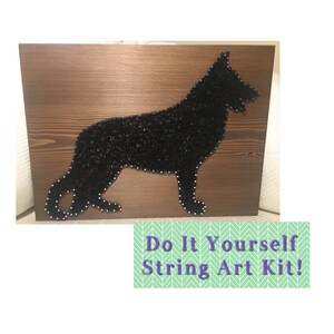 May include: A black string art silhouette of a German Shepherd dog on a brown wooden background. The text "Do It Yourself String Art Kit!" is on a green background with a chevron pattern.