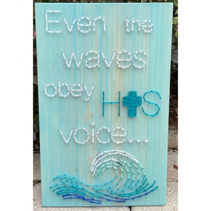May include: A wooden sign with the text "Even the waves obey His voice..." in white string art. A blue wave is depicted below the text.