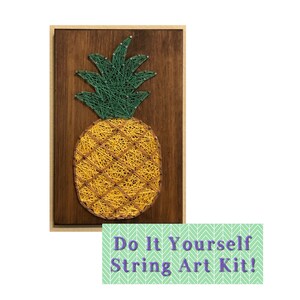 May include: Do It Yourself String Art Kit! A string art kit featuring a pineapple design on a wooden board. The pineapple is made with green and yellow string.