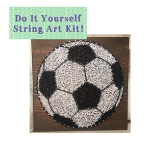 May include: A DIY string art kit featuring a black and white soccer ball design. The soccer ball is made of string wrapped around nails hammered into a wooden board.