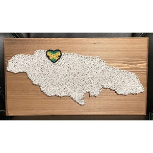 May include: String art of Jamaica in the shape of the island with a heart-shaped Jamaican flag in the center.